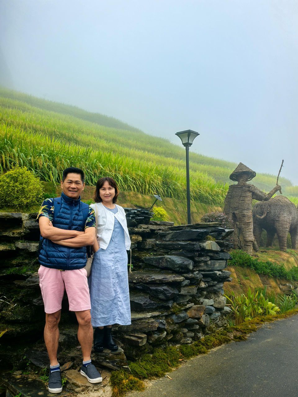 Couple at misty rice terraces with scenic views